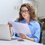 businesswoman looking at files in office