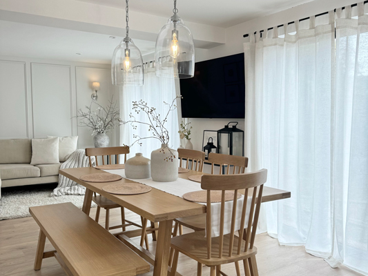 Custom sheer curtains with linen blends bring a airy vibe to the living room