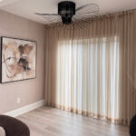 Custom sheer curtains with linen blends bring a airy vibe to the living room
