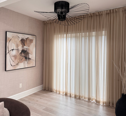 Custom sheer curtains with linen blends bring a airy vibe to the living room