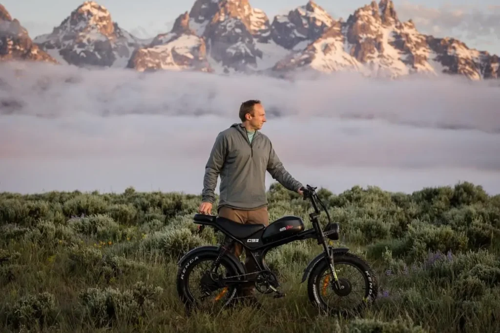 Emoko C93 moped-style e-bike with a mountain view