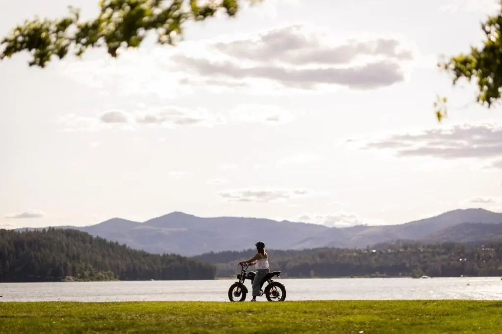 Emoko C93 electric bike beside a lakeside landscape